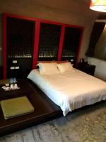 a bedroom with a large bed and a table at Hotian Inn in Donggang