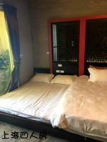 two twin beds in a room with a window at Hotian Inn in Donggang
