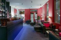 a bar with red walls and couches and chairs at Best Western Hotel de la Breche in Niort