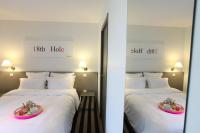 a hotel room with two beds with a plate of food at Hotel 202 in Hossegor