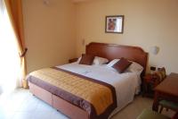 A bed or beds in a room at Grand Hotel Moroni