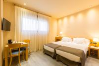 Postel nebo postele na pokoji v ubytování Apartamentos DV