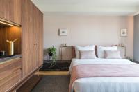 A bed or beds in a room at Perianth Hotel