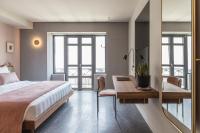 A bed or beds in a room at Perianth Hotel