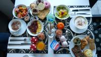 a table topped with plates of breakfast food on a table at Hotel 202 in Hossegor