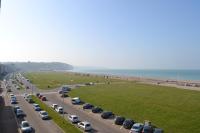 a highway with a lot of cars parked next to the beach at Hotel de l&#39;Europe in Dieppe