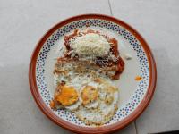 a plate of breakfast food with eggs and waffles at Casa Arcoiris Zihuatanejo B&B in Zihuatanejo