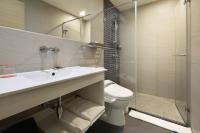 a bathroom with a sink and a toilet and a shower at KUN Hotel in Taichung