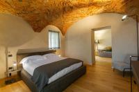 A bed or beds in a room at Relais San Vigilio al Castello