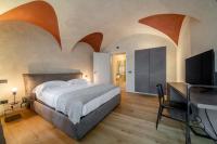 A bed or beds in a room at Relais San Vigilio al Castello