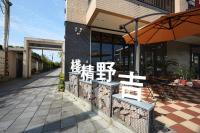 a restaurant with a bench and an umbrella at Ji Ye Jing Zhan B&amp;B in Ji&#39;an