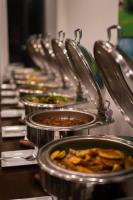 a row of metal pots filled with food on a table at The Habitat Kosgoda by Asia Leisure in Bentota