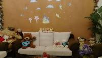 a group of stuffed teddy bears sitting on a couch at sweet home B&amp;B in Hualien City