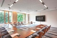 a meeting room with a large table and chairs at Meliá Düsseldorf in Düsseldorf