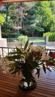 a vase filled with flowers sitting on a deck at Gite Le Moulin de Rosieres Moulin Champetier in Rosières