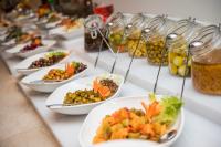 a buffet with plates of food on a table at Kuwait Grand Hotel in Kuwait