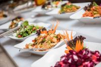 a row of plates of food on a table at Kuwait Grand Hotel in Kuwait