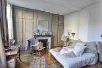 a living room with a white couch and a fireplace at Appartement type parisien 75m² in Beauvais