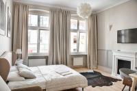 Televízia a/alebo spoločenská miestnosť v ubytovaní Apartament Kopernika 25