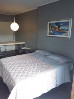 A bed or beds in a room at Uniclub House