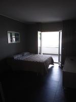 A bed or beds in a room at Uniclub House