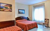 Posteľ alebo postele v izbe v ubytovaní Hotel Pavone