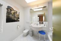 a bathroom with a sink and a toilet and a mirror at Am Neutor Hotel Salzburg Zentrum in Salzburg