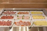 a tray of different types of meats and cheese at Am Neutor Hotel Salzburg Zentrum in Salzburg
