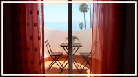 a room with red curtains and a table and chairs at Casa Las Toro Playa in Chilches