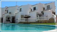 a white house with a swimming pool in front of it at Casa Las Toro Playa in Chilches