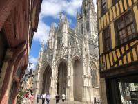 a large cathedral with people walking in front of it at Hôtel De La Cathédrale in Rouen
