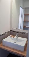a bathroom with a white sink and a mirror at Val&#39; Appart 1 in Valenciennes