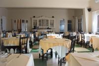 a dining room with tables and chairs with white tablecloths at Hotel Parque Oceánico in La Coronilla