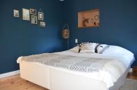 a bedroom with a white bed with a blue wall at Mas Mialou in Saint-Jean-du-Gard