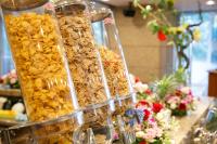 a group of containers of food on a counter with flowers at Day Nice Hotel Tokyo in Tokyo
