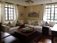 a living room with a couch and a table at Hob House in Nairobi