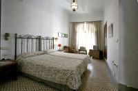 a bedroom with a large bed and a window at Posada de Palacio in Sanlúcar de Barrameda