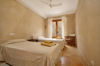 A bed or beds in a room at Teulada