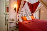 a bedroom with a red bed with orange pillows at Alla Vite Dorata in Venice