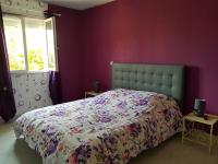 a bedroom with a bed in a purple wall at 19 Rue du Cadran in Montmorillon