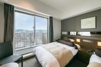 a bedroom with a bed and a large window at Hotel Miyahira  in Ishigaki Island