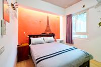 a bedroom with a bed with the eiffel tower on the wall at Corner Inn九份住宿I 小角落民宿I 機車租借I日夜間導覽 in Jiufen