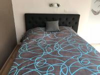 a bedroom with a bed with a blue and gray blanket at Lumineux T2 Vieille ville 3 pers parking gratuit - by La Source d&#39;OrFée in Boulogne-sur-Mer