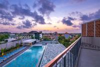 a view of a swimming pool on a balcony at Eastin Ashta Resort Canggu in Canggu