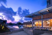 an exterior view of a building with a swimming pool at Eastin Ashta Resort Canggu in Canggu