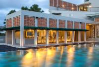 a hotel with a swimming pool in front of a building at Eastin Ashta Resort Canggu in Canggu
