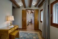 a hallway with a room with a table and a window at Hotel Santa Chiara in Venice