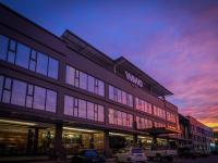 a building with cars parked in front of it at WIWO Hotel in Bintulu