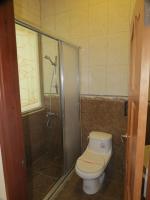 a bathroom with a toilet and a shower at Seasons Inn in Jiaoxi