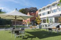 a group of tables and chairs under a white umbrella at The Lincoln Hotel in Lincoln
